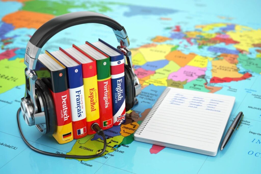 picture showing books with different languages, a map, and headphones
