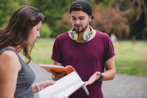 two young students learning something using the notes