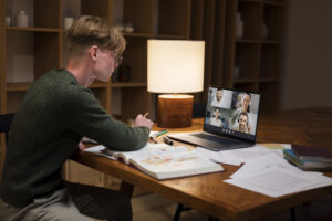 a young man learning in virtual classroom