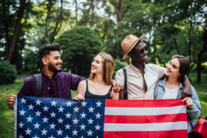 Happy four students with us flag