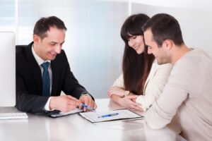 a couple at a bank signing papers